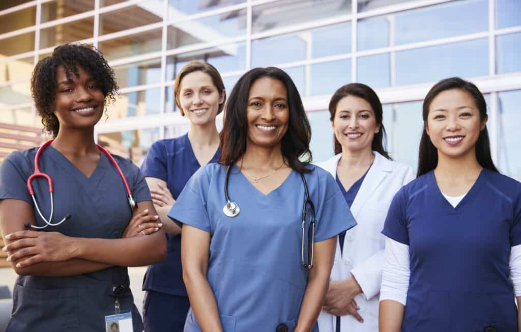 Female healthcare colleagues standing outside hospital
